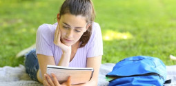 student studying reading notes outdoor