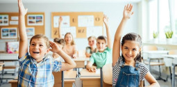 Children are raising hand in Elementary School